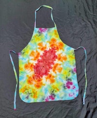 a tie dye apron on a black background