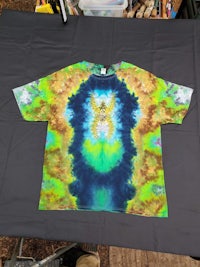 a tie dye t - shirt on a table