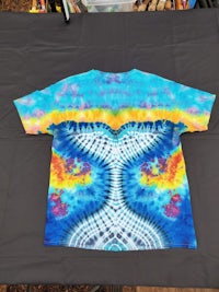 a tie dye t - shirt on a table