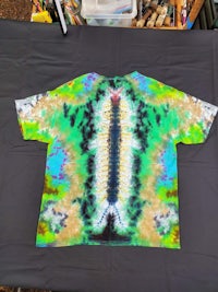 a tie dye t - shirt on a table