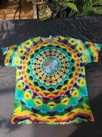 a tie dye t - shirt with a colorful design on it