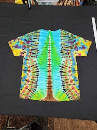 a tie dye t - shirt on a table