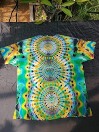 a tie dye t - shirt with a colorful design on it